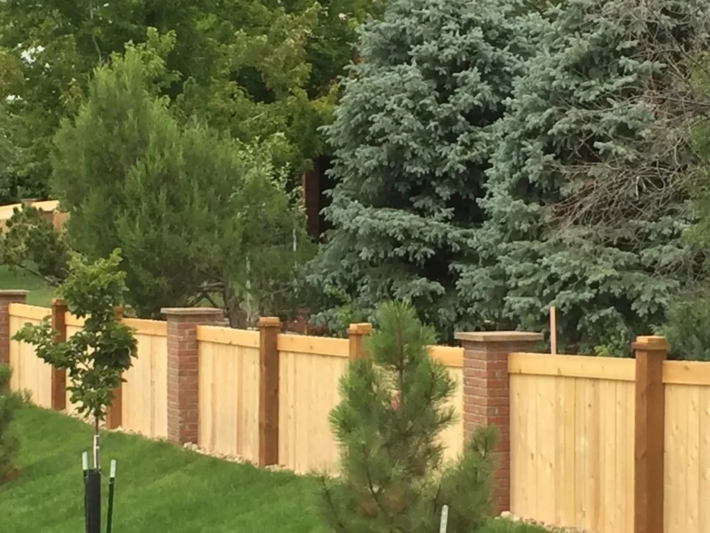 Commercial unstained wooden split rail fence installation front of business.